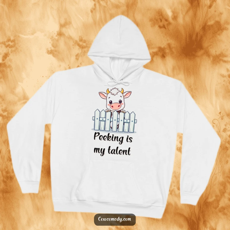Funny hoodie with a curious cow peeking over a picket fence, offering warmth and farm-themed humor.