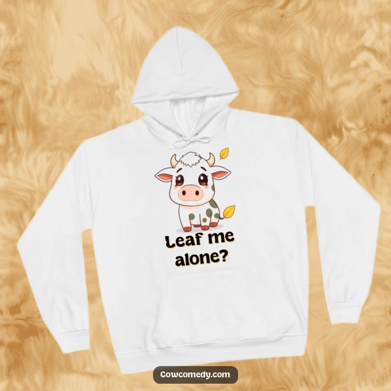 Funny hoodie illustration of a surprised cow watching a falling autumn leaf. Comfortable and humorous outerwear for the season.