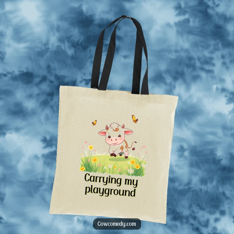 Funny playful cow tote bag featuring a cow chasing a butterfly through a meadow, ideal for carrying essentials.